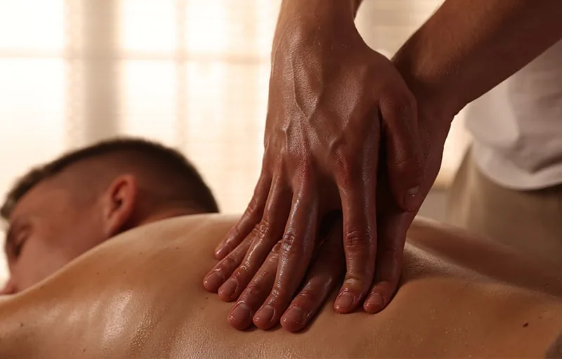 Therapist performing deep tissue massage technique